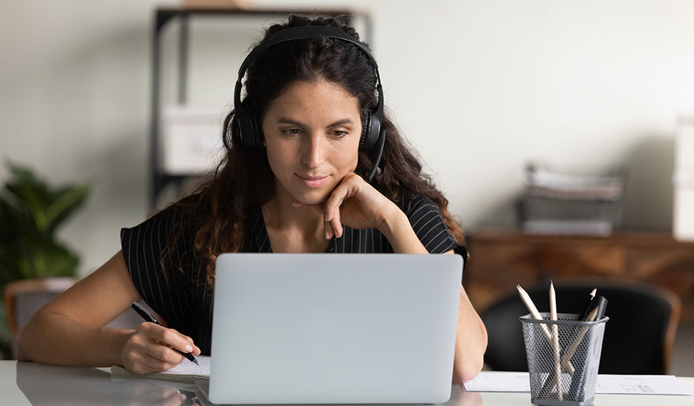 Woman enjoying her VoIP call on her computer