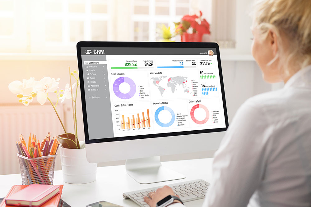 Woman viewing performanc emetrics on a monitor