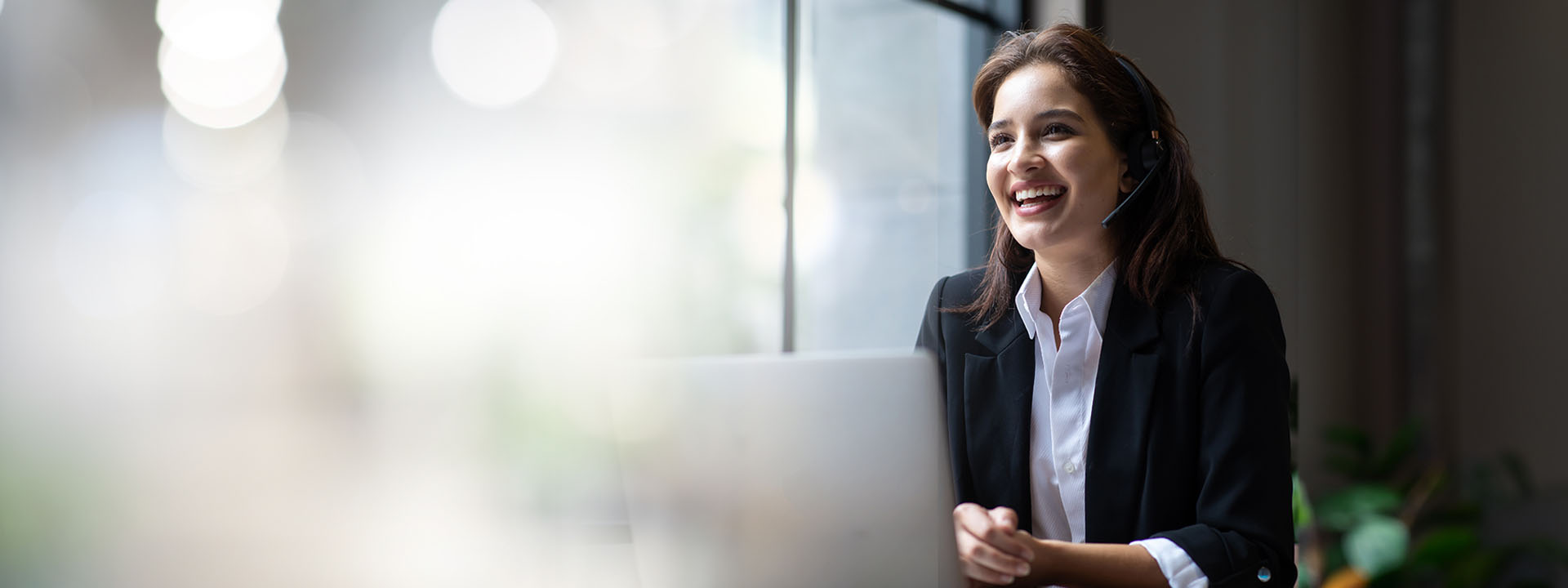 Businesswoman using VoIP phone to call customers