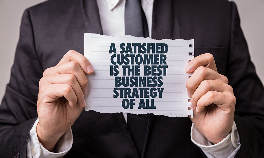 Businessman holding banner about customer satisfaction